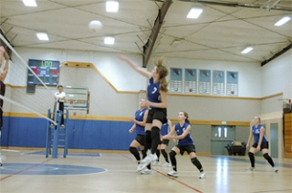 Grace Academy hitter Katie Mittelstaedt goes for a kill against Lummi.