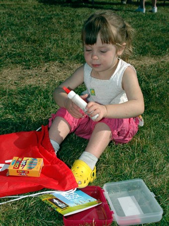 Incoming preschool student Alexis Binckley sorts through her school supplies at the Allen Creek Elementary Summer Jubilee on Aug. 20.