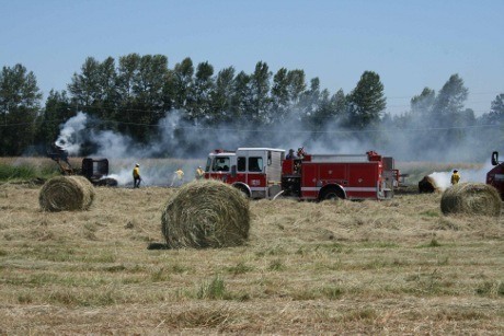 Marysville Fire District crews work to exztinguish a grass fire the size of a football field in the area of 156th Street NE and 23rd Avenue NE