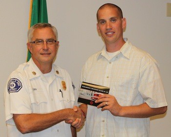 Marysville Fire Chief Greg Corn congratulates Tristan Brenner on graduating the University of Washington and Harborview Medical Center Paramedic Training Program