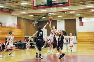 Freshman Dacia Heckendorf hooks the ball in a second-half attempt. Heckendorf had four points for the Tomahawks