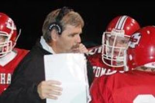 M-P assistant coach Scott Stokes talks to members of  the offense between action Friday