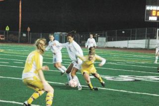 Senior midfielder Kassandra Riozzi tries to get a takeaway from a driving Lake Stevens offense.