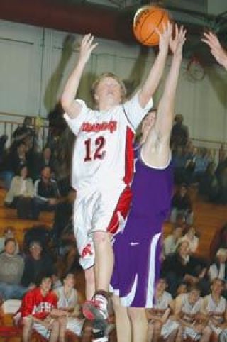 Senior guard Ricky Holm drives to the hoop against a couple of Kamiak defenders Tuesday