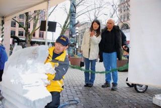 Lake Stevens resident Chan Kitburi touches up a creation during the Pioneer Square Historic Holidays on Dec. 16