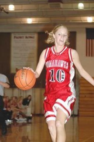 Senior guard and co-captain Nancy Couls moves the ball down the court Saturday