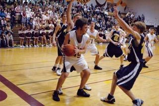 Lakewood forward Sean Noteboom looks to pass between two Burlington-Edison defenders in the Cougars 53-39 loss Feb. 22.