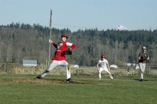 While a teammate watches the pitch from first base