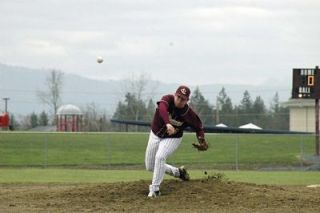 Senior pitcher Derek Graefenauer kicks up some dirt in a rainy game against Archbishop Murphy.