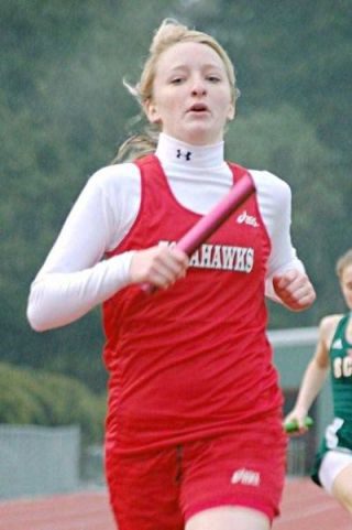 Senior sprinter Nicolette Runyan carries the baton in M-Ps winning 4x100 relay.