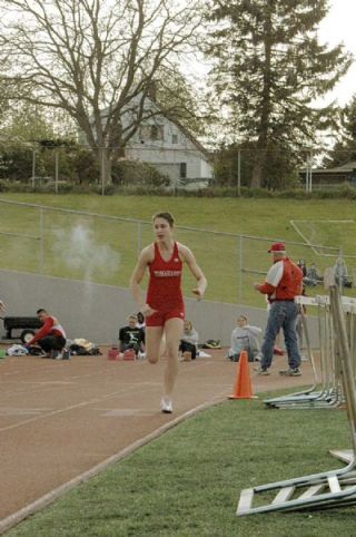 Smoke still hangs in the air as freshman Dacia Heckendorf competes in the girls 100-meter dash finals at Snohomish May 9.