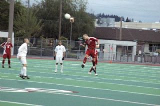 Senior midfielder Nick Burdett heads the ball in the Tomahawks state tournament opener against Puyallup. Burdett had the assist on M-Ps goal.