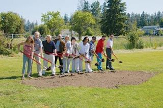 Community members turn the first spades of dirt during groundbreaking ceremonies for the new Grove Elementary School on June 2. From left here are Marysville School Board director Darci Becker