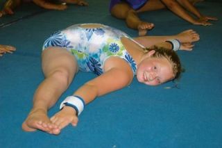 Sydney Kitchins demonstrates her flexibility by holding in the splits.