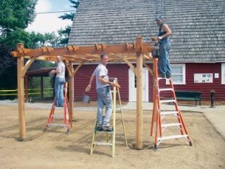 Employees from Belmark Homes put a finishing coat of stain on one of two new pergolas donated and installed by the Marysville construction company in Jennings Memorial Park last week.  Brushing up on their community service here are