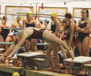 Freshman swimmer Jewel Levalley dives into the M-P pool during a Sept. 4 jamboree against conference rivals.