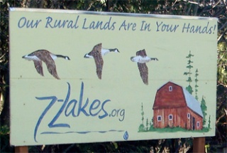 Two hand-painted signs depicting three Canada geese and a red barn and declaring “Our rural lands are in your hands” were stolen recently from Lakewood. Posted  outside of the Lakewood store by permission of the owner