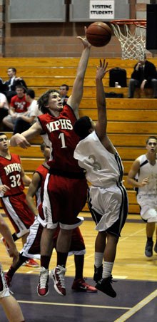 Ryan Shannon knocks one of his seven blocks away from the basket. Shannon also scored a game-high 29 points and pulled down 13 rebounds against Kamiak.