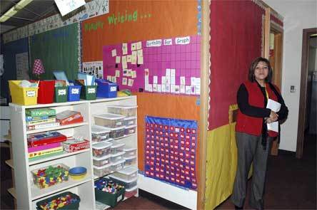 Cascade Elementary Principal Teresa Iyall-Williams stands next to a school book room that can only be accessed by entering a kindergarten classroom.