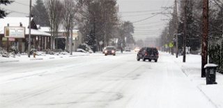 Cars on Cedar Avenue in Marysville navigate the snow-covered streets Wednesday morning.