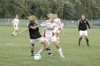 Sophomore midfielder Kiley Thomason gets up close with her Lake Stevens counterpart