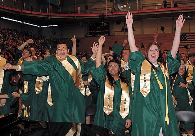 Marysville Getchell High School Class of 2012 graduates throw their caps in the air at the close of their commencement on June 13 in the Everett Community College Fitness Center.