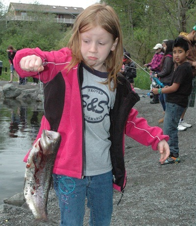 Emily Weaver looked a bit leery of her catch at the 20th annual free fishing derby at Jennings Park on May 3.