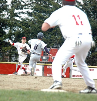 Arlington runner Curtis Johnson slides into second as M-P shortstop Steve Shane turns the double play at second base.