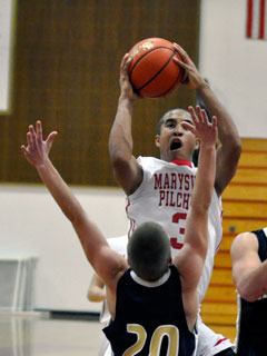 Marysville-Pilchuck guard Dom Kiblinger takes a shot during the first overtime period against Arlington.