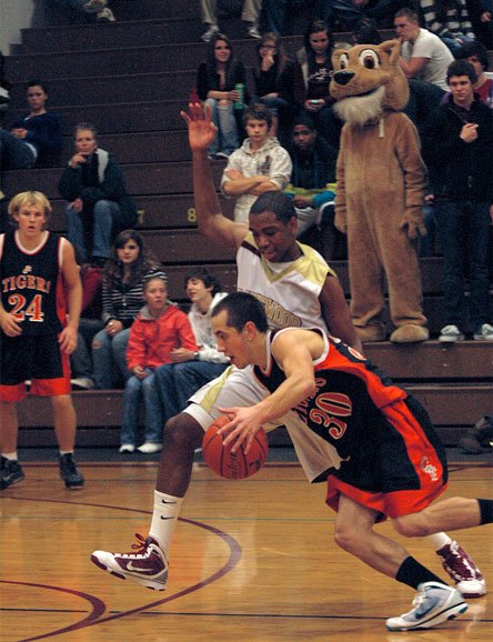 Junior forward Tre' Haslom keeps Granite Falls guard Max Whitt from penetrating the Lakewood zone.