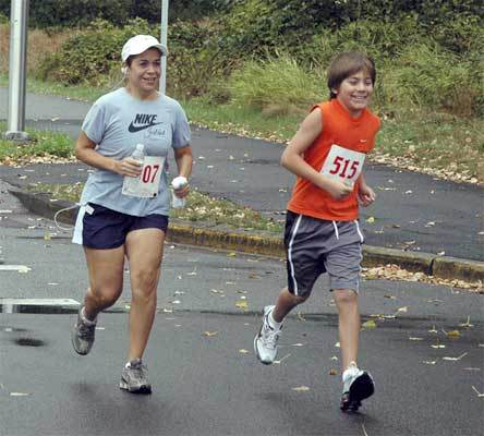 Five-mile runners in the Marysville YMCA Fun Run pace themselves as the sky gently mists on them.