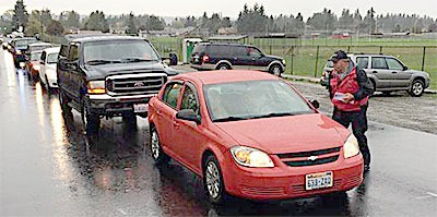 Cars surround M-P high school Saturday after the police investigation ended as students wanted to retrieve items they left after Friday's shooting.