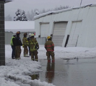 Marysville Fire District crews assess the damage to an industrial building in Marysville whose roof collapsed Dec. 22 just before 7 a.m.