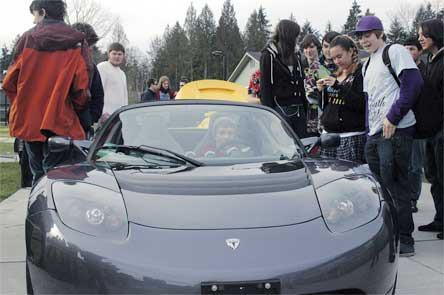 Marysville Arts and Technology High School students check out two Tesla Roadsters on Friday