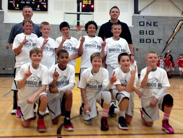 Players and coaches from the Marysville AAU Basketball boys fifth-grade Wesco team pose after winning the league tournament on Sunday