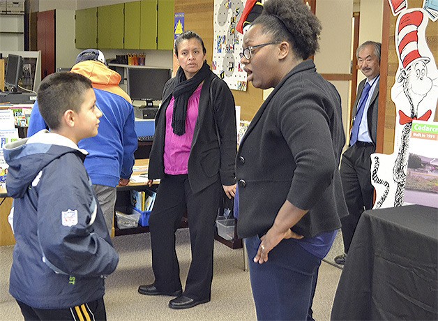 Liberty Elementary Principal Gloria Henderson talks to a student and his family at the Open House at the school Monday night. Three similar open houses will take place at other schools this week.