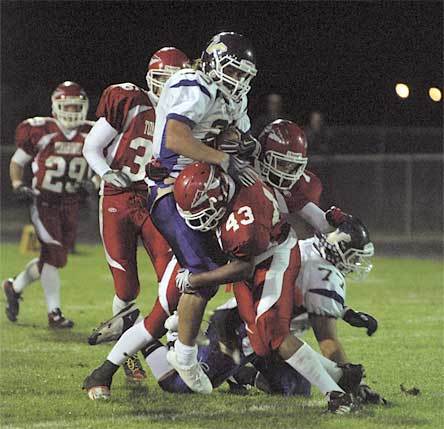 A group of M-P defenders gang tackle a Lake Stevens running back.