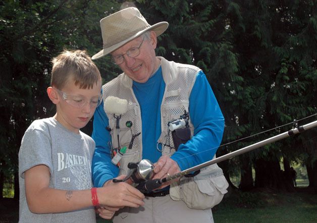 Marysville’s Blake Mallonee gets tips on fishing from his grandfather Jim Mallonee at the Twin Lakes County Park during its May 19 family fishing event.