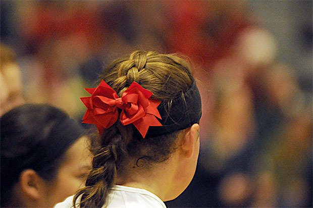 Arlington cheerleaders and volleyball players wore red ribbons in their hair to honor Marysville-Pilchuck. The crowd also was wearing red to support the high school where the recent shooting took place.