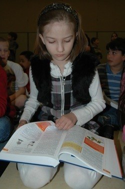 Grove Elementary third-grader Leyla Al-Anzi starts putting her new dictionary to use shortly after receiving it from the Marysville Rotary Club on March 4.