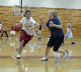 Sophomore Dacia Heckendorf holds off a defender as she drives for the basket.