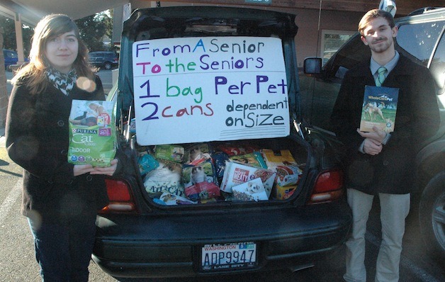 Kaliene Kopp and Colton McGuire are handing out bags of pet food to seniors at the Marysville Community Food Bank on Mondays.