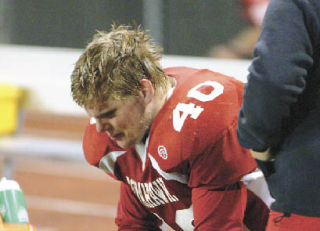 Tomahawk senior Ryan Sterley finds it hard to watch as M-P trails Issaquah. The Tommies were eliminated with a 36-18 loss.