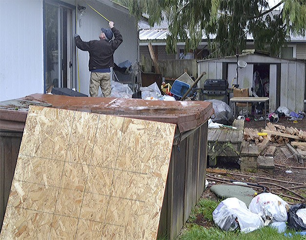 City workers board up a house in North Marysville for health and safety concerns Feb. 19. Neighbors said for about six years it had been a drug house inhabited for a number of those years by squatters.