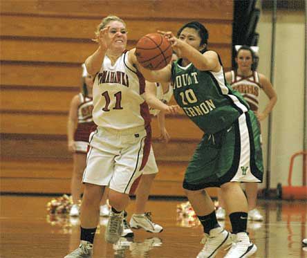 Marysville-Pilchuck junior Morgan Martinis deflects a Mount Vernon pass away from Sheirelyn Santos during the lady Tomahawks’ 54-39 win.