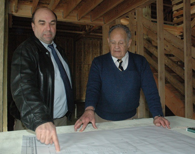 Marysville Historical Society Museum Project Manager Steve Muller and MHS President Ken Cage compare the plans for the museum structure to the facility that’s since been built.