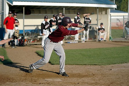 Lakewood catcher Michael Leach moves runners over in the seventh inning with a sacrifice bunt. It was one of three Cougar bunts in the inning to take the lead at 8-7.