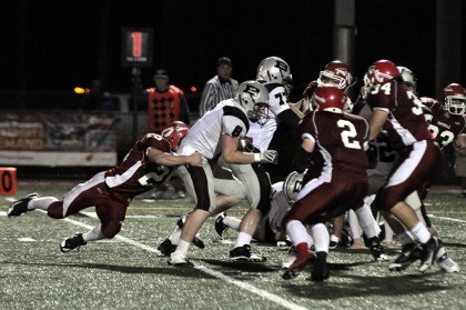 Cody House brings down Bethel quarterback Drew Austin behind the line of scrimmage.