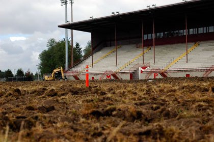 Construction machinery excavates the innards of the field in front of Harry Lang Stadium at Marysville-Pilchuck.