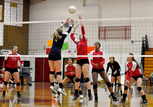 Sophomore middle back Marley Reynolds leaps to contest Arlington’s Vanessa Van Eyk’s shot as